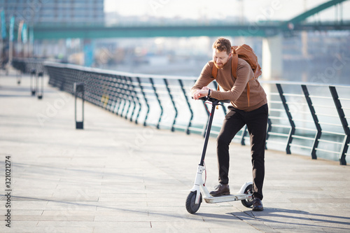 Young businessman on e scooter in the city