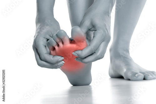 woman massaging her painful foot photo