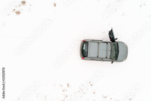 Top view on a car that stands in a snow-covered field.