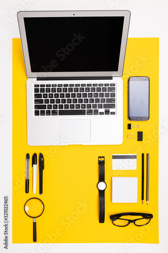 office workplace. stationery with laptop, credit card with mockup, phone and magnifying glass lie on the table