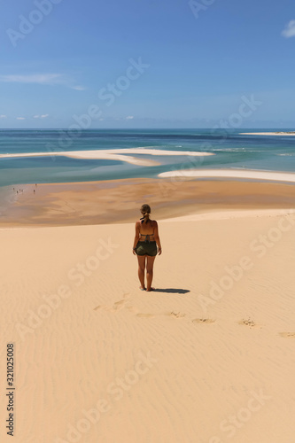 woman with green bikini overlooking sand banks and turquoise water