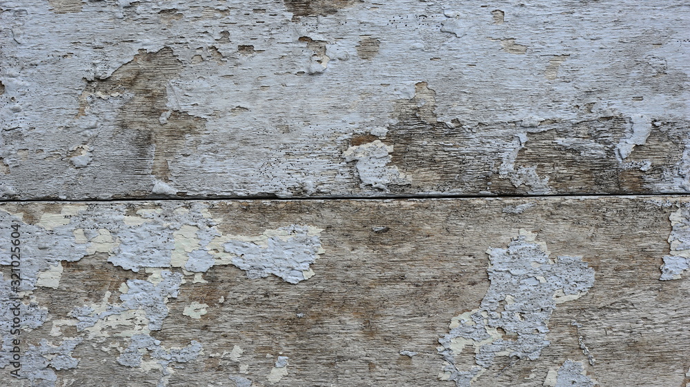 Obraz premium The white wooden planks of the house which have started to decay and have holes, Grunge colour
