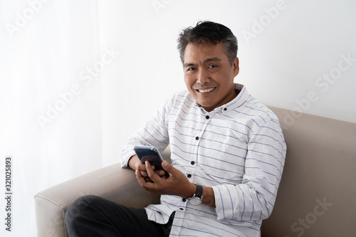 portrait of indonesian mature asian businessman smiling