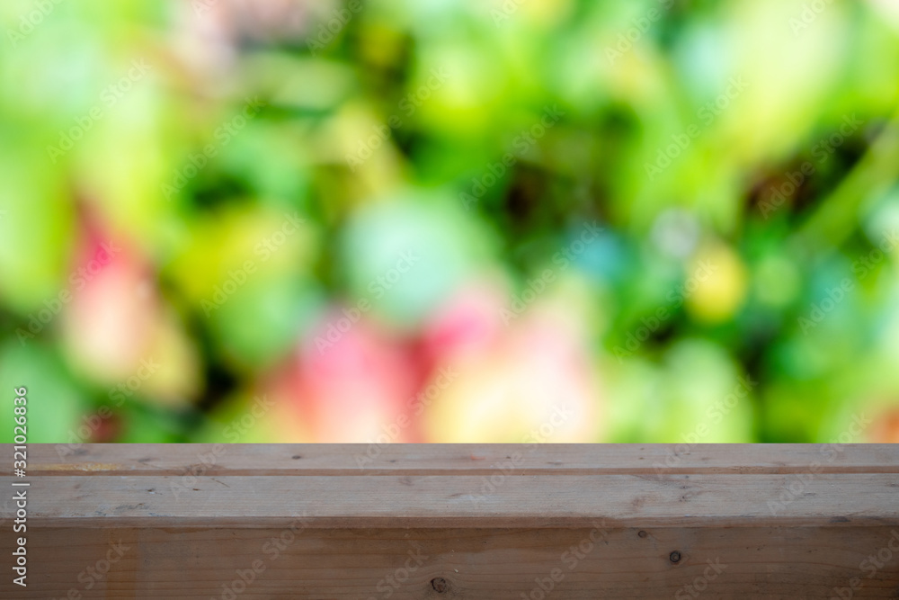 Wood table top on blurred green background - can be used for montage or display your products Wood table top on blurred green background - can be used for montage or display your products