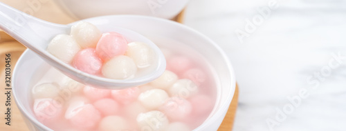 Tang yuan  tangyuan  delicious red and white rice dumpling balls in a small bowl. Asian traditional festive food for Chinese Winter Solstice Festival  close up.