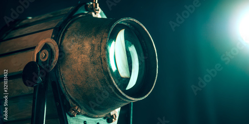 Projector lens on dark background. Close up of old retro things shoot with vintage style colors and toned. Flyer for your ad. Concept of retro style, history return, fashioned things, hobby, memories.