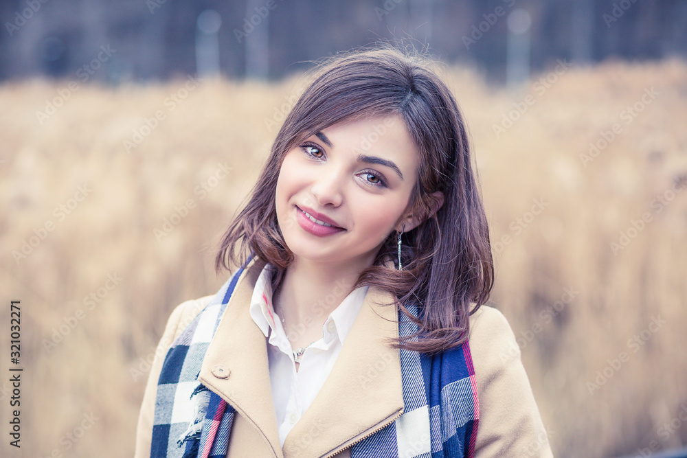 Woman smiling with perfect smile and white teeth in a park and looking at camera Woman smiling with perfect smile and white teeth in a park and looking at camera