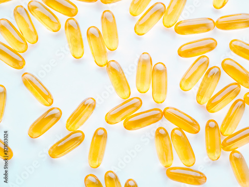 Yellow pills with Omega 3. Macro photo, top view.