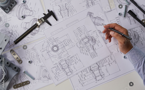 Tableau sur toile Engineer technician designing drawings mechanical parts engineering Engine