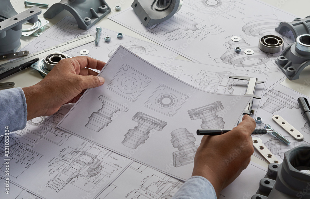 Engineer technician designing drawings mechanical parts engineering ...
