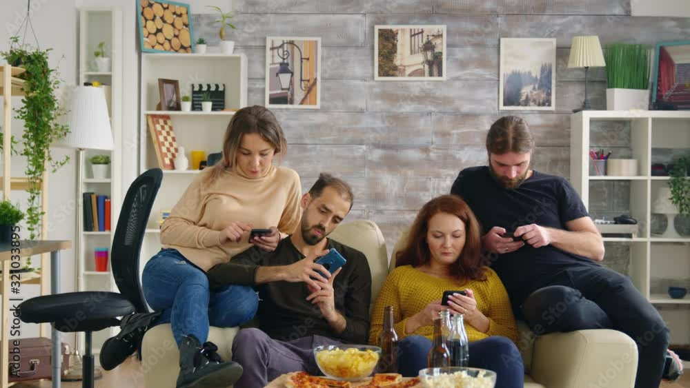 Group of friends sitting on couch in living room Group of friends sitting on couch in living room