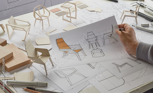 Designer sketching drawing design development product plan draft chair armchair Wingback Interior furniture prototype manufacturing production. designer studio concept . photo