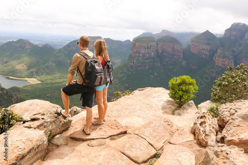 hiking couple standing at edge of mountain photo