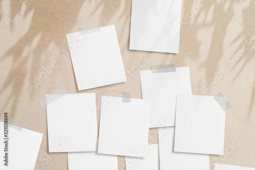 Moodboard template composition with blank photo cards, torn paper, square frame glued with adhesive tape on light paper background with floral overlay shadows as template.