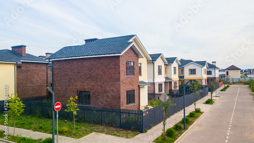 House building cottage village and city construction concept: evening outdoor urban view of modern real estate homes