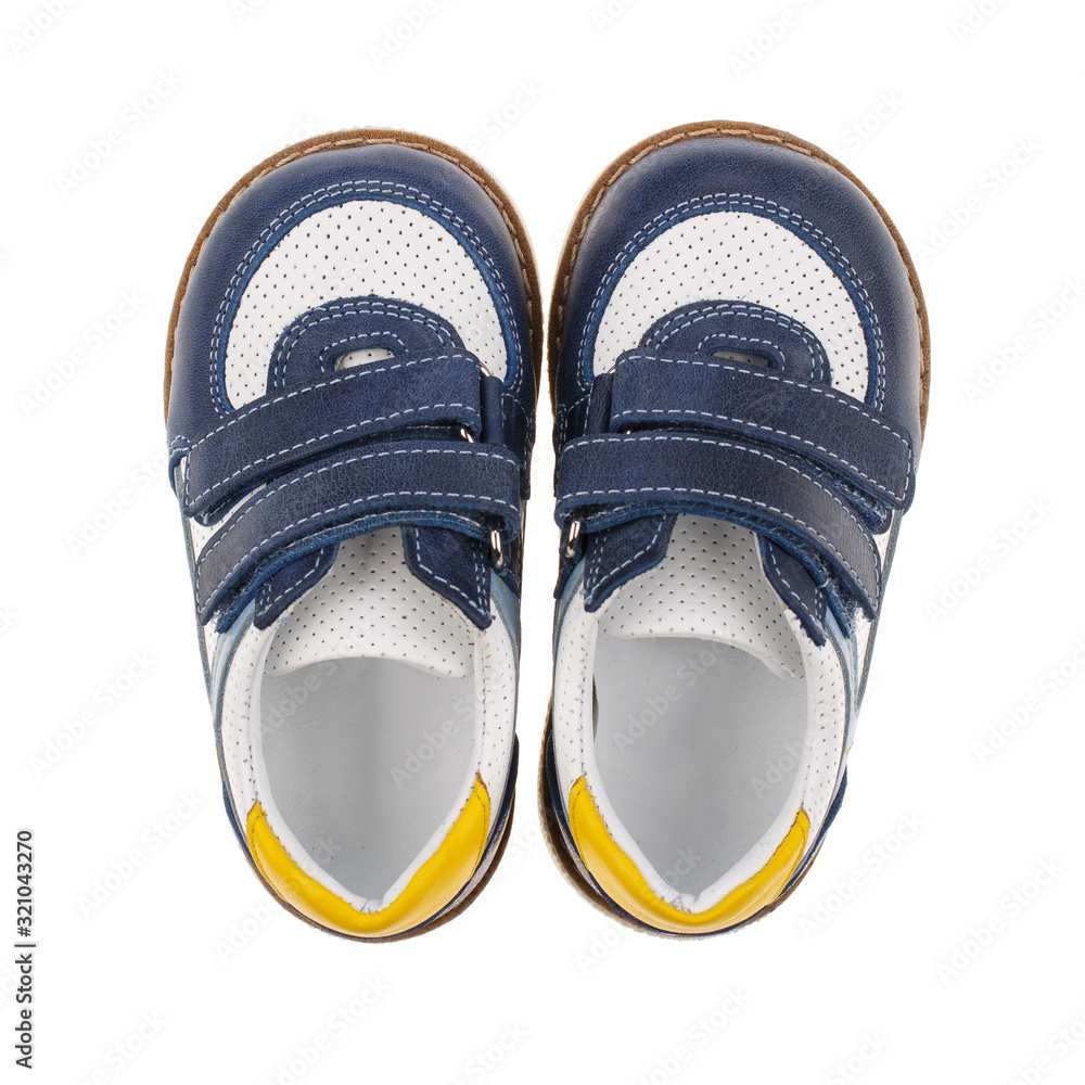 Children's blue and white shoes for boys isolated on white. Top view