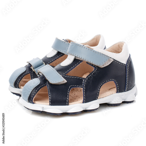 Baby black sandals for boys with blue inserts isolated on white. Side view