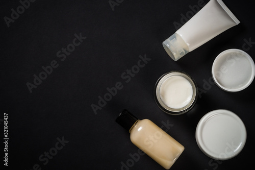 Natural cosmetics on black background.