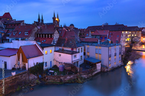 Aerial panoramic view of Old town of Bamberg over the Regnitz river with Michelsberg monastery at night, Bavaria, Upper Franconia, Germany