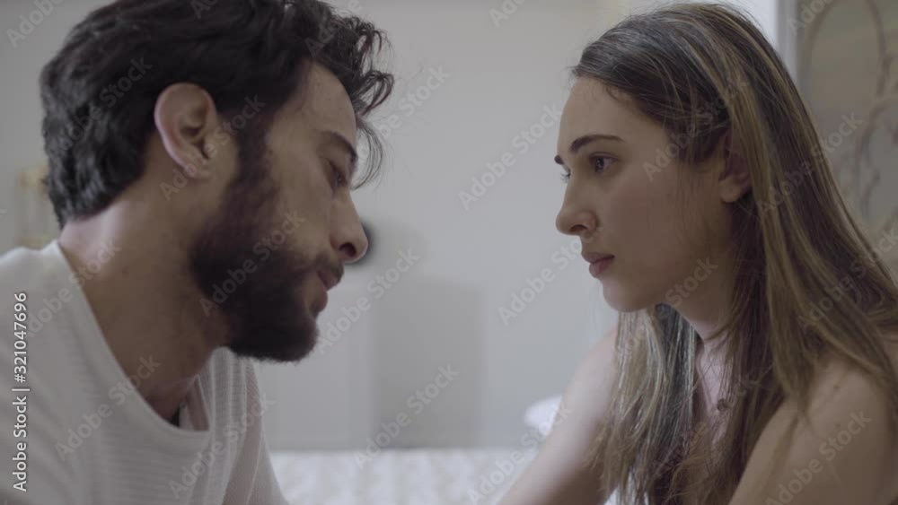 beautiful couple having An intimate Moment of love, Looking at Each Other in bed. beautiful couple having An intimate Moment of love, Looking at Each Other in bed.