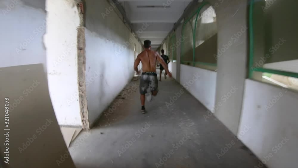 two freerunners escaping from a room to run run along a floor ending up ...