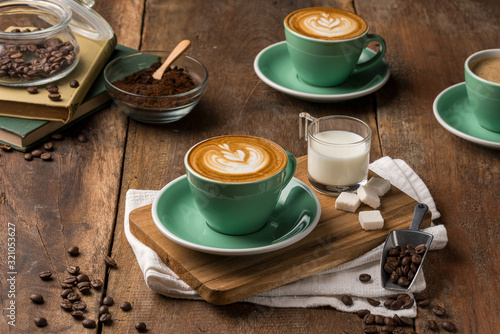 Hot coffee decorated with chocolate, sugar and coffee beans. 