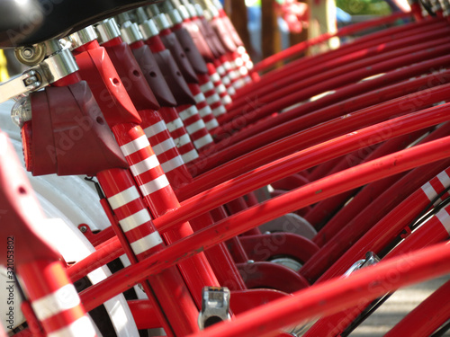 row of red bikes for rent bikesharing