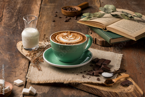 Fotografie Hot coffee decorated with chocolate, sugar and coffee beans.