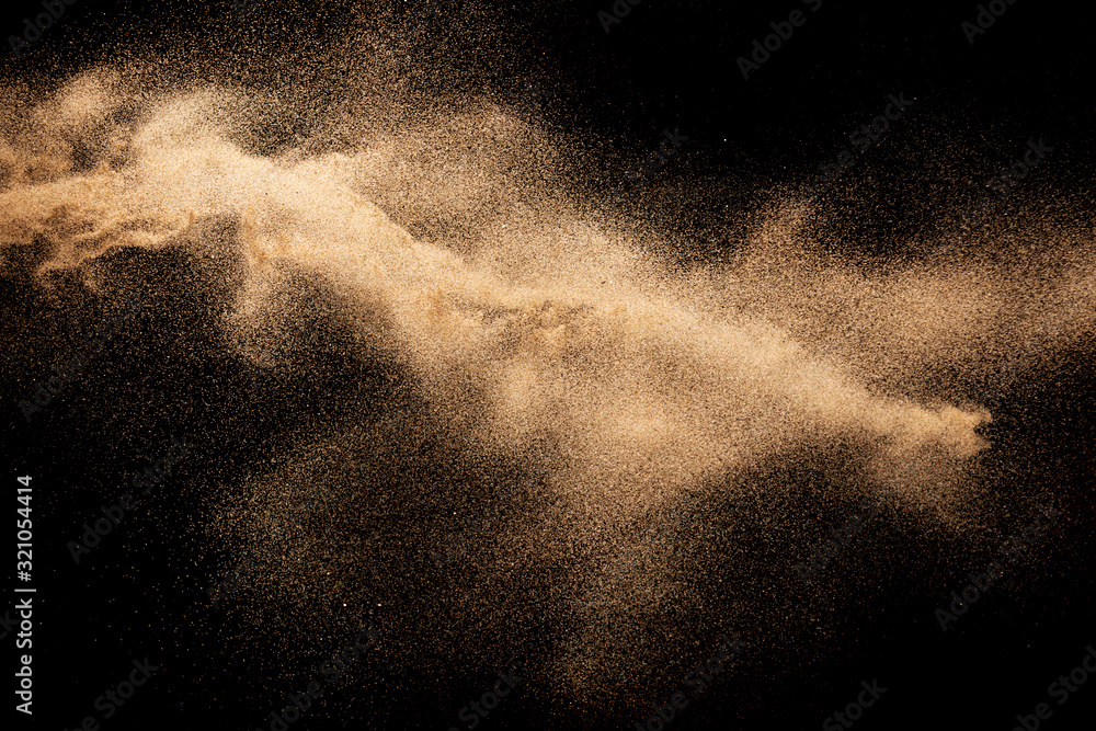 Brown dry river sand explosion isolated on black background. Abstract sand splash. - obrazy, fototapety, plakaty 