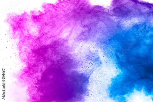 Explosion of blue pink colored powder isolated on white background.Pink blue dust splash.
