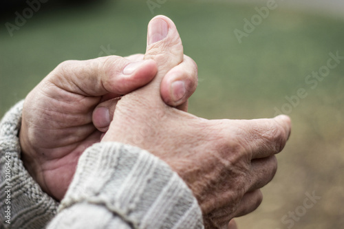 Elderly man has pain in fingers and hands  photo