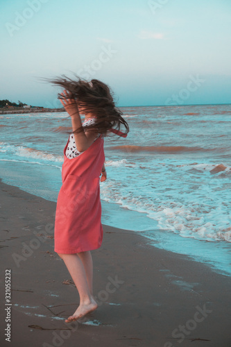 Girl dancing on the seashore