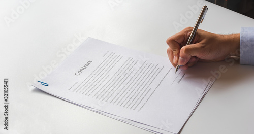 White table with paper contract detail and empty space to sign authorized signature