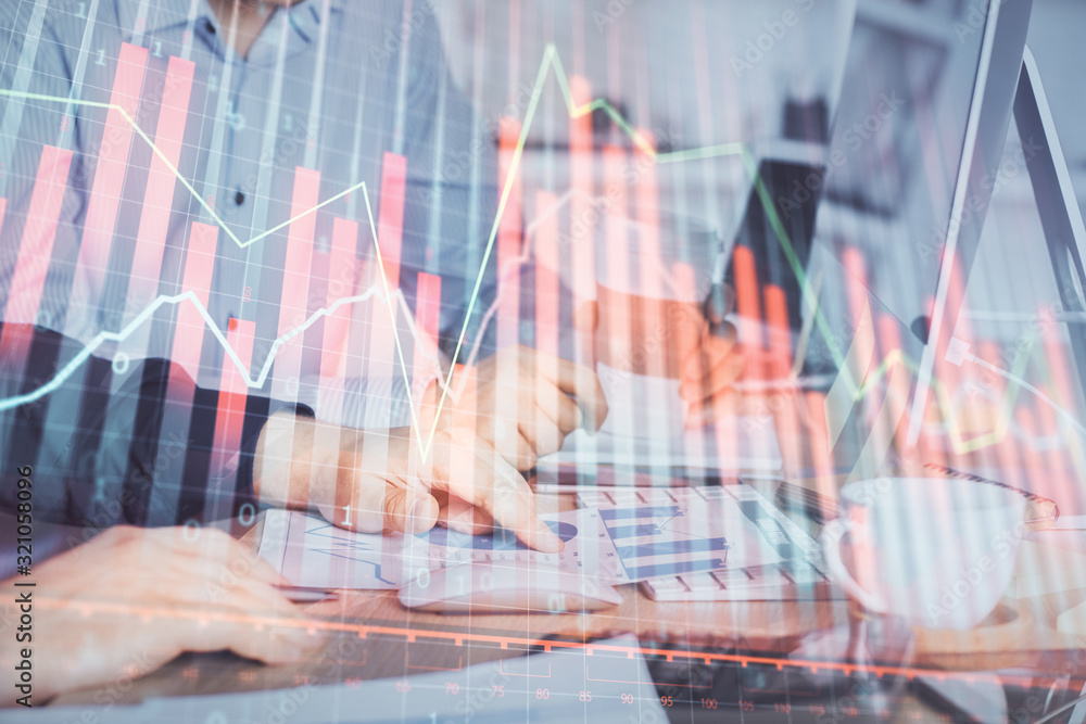 Multi exposure of chart with man typing on computer in office on background. Concept of hard work. Multi exposure of chart with man typing on computer in office on background. Concept of hard work.