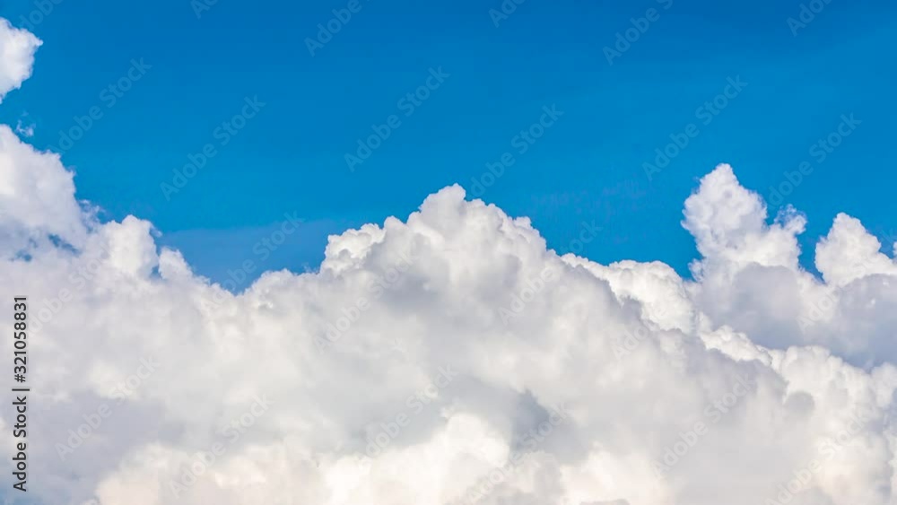 Timelapse white clouds gathered and flowing ,blue sky background Timelapse white clouds gathered and flowing ,blue sky background