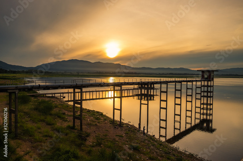 Sun rising at The long bridge on bangpra reservoir , Chonburi Thailand. photo