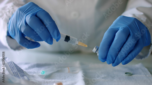 Doctor prepares injection syringe