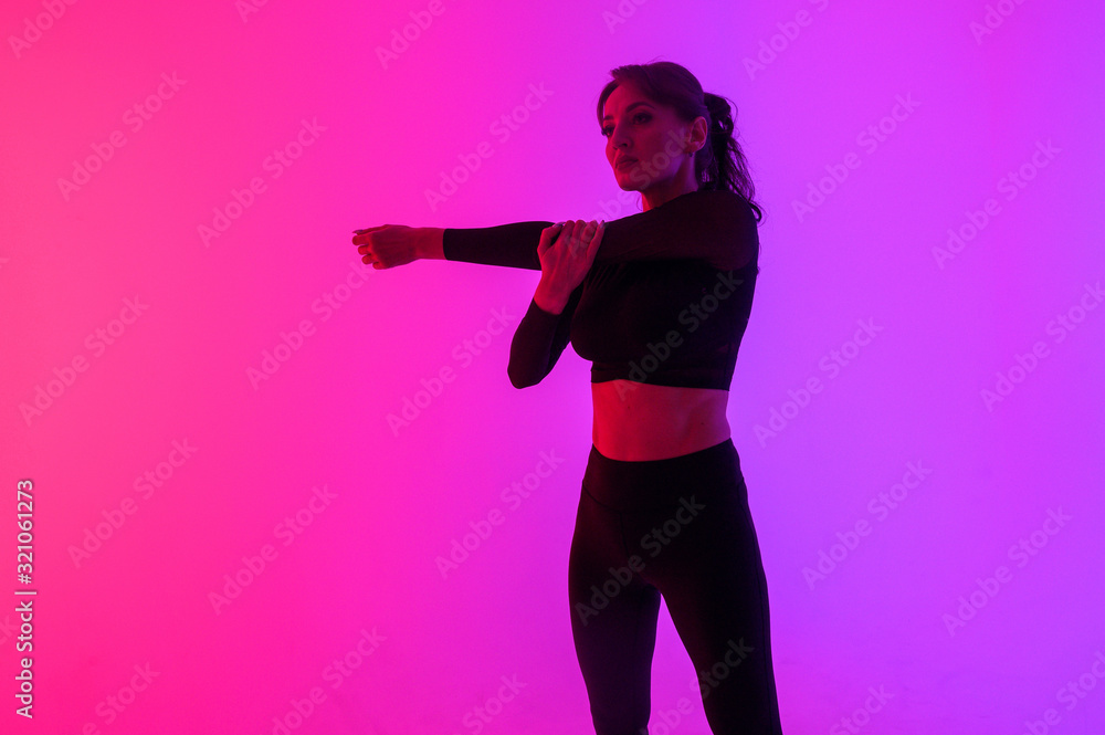 young athlete on a bright background flexes before training young athlete on a bright background flexes before training
