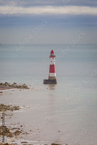Beachy Head lighthouse off the Sussex coast, with calm waters surrounding