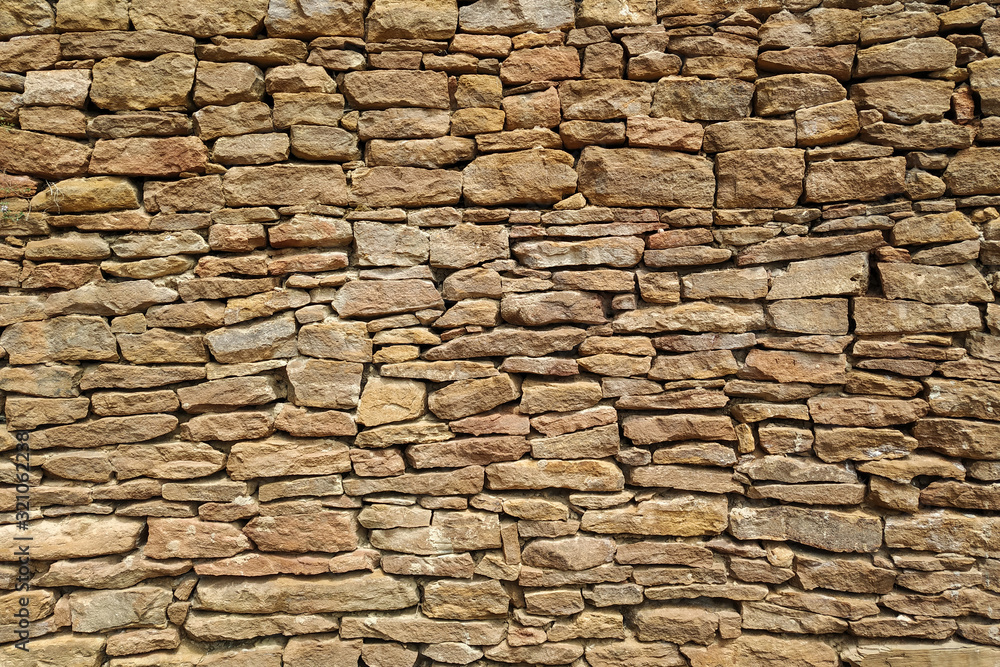 Fototapeta premium Old castle stone wall texture background. Part. Sand color, natural stone. Design.