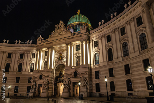 Vienna, Austria. Hofburg Palace main entrance seen from Michaelerplatz at night, wide-angle view at dusk, Habsburg Empire landmark in Vienna