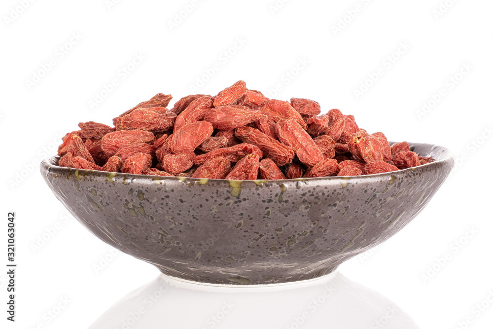 Lot of whole dried red goji in glazed bowl isolated on white background Lot of whole dried red goji in glazed bowl isolated on white background
