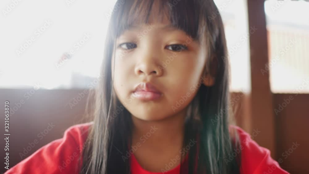 Close Up children when eating lunch and looking smartphone Close Up children when eating lunch and looking smartphone