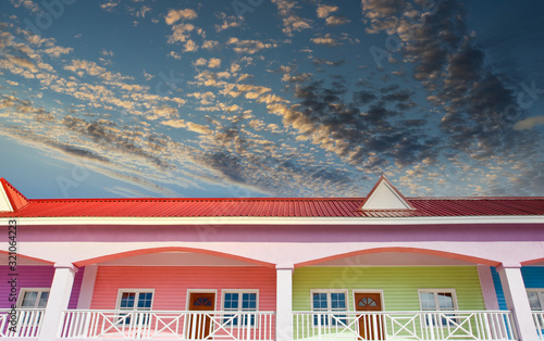 Brightly colored shops against a blue sky