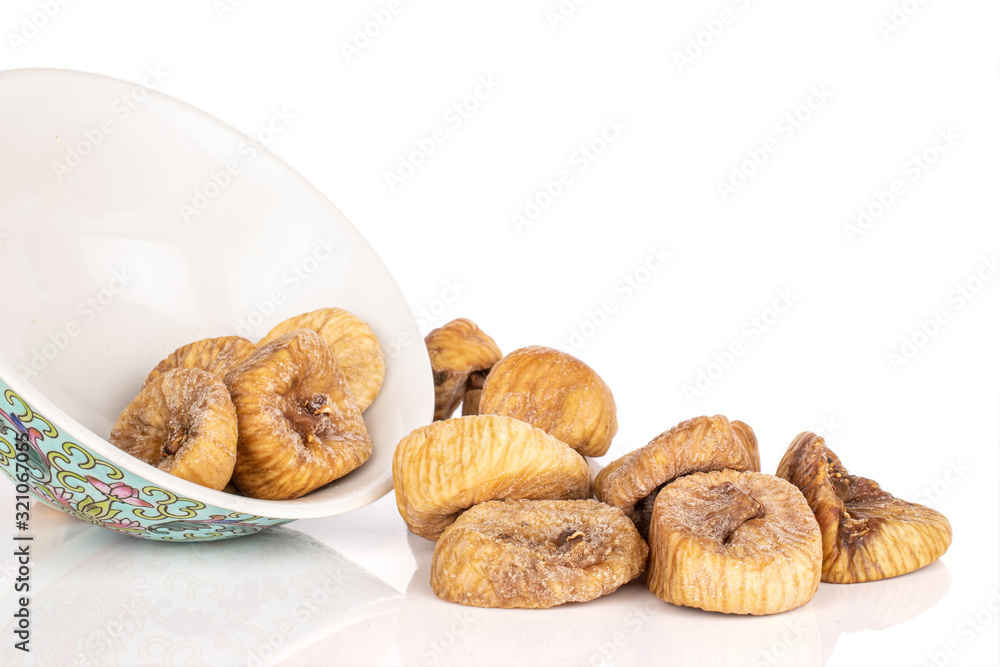 Lot of whole dried fig with blue chinese ceramic bowl isolated on white background