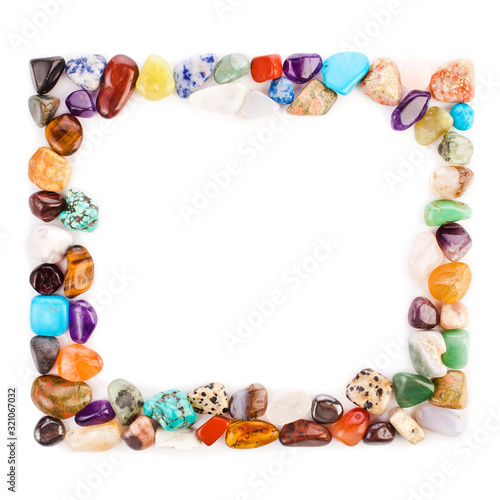Frame made of colorful semiprecious gemstones on a white background.