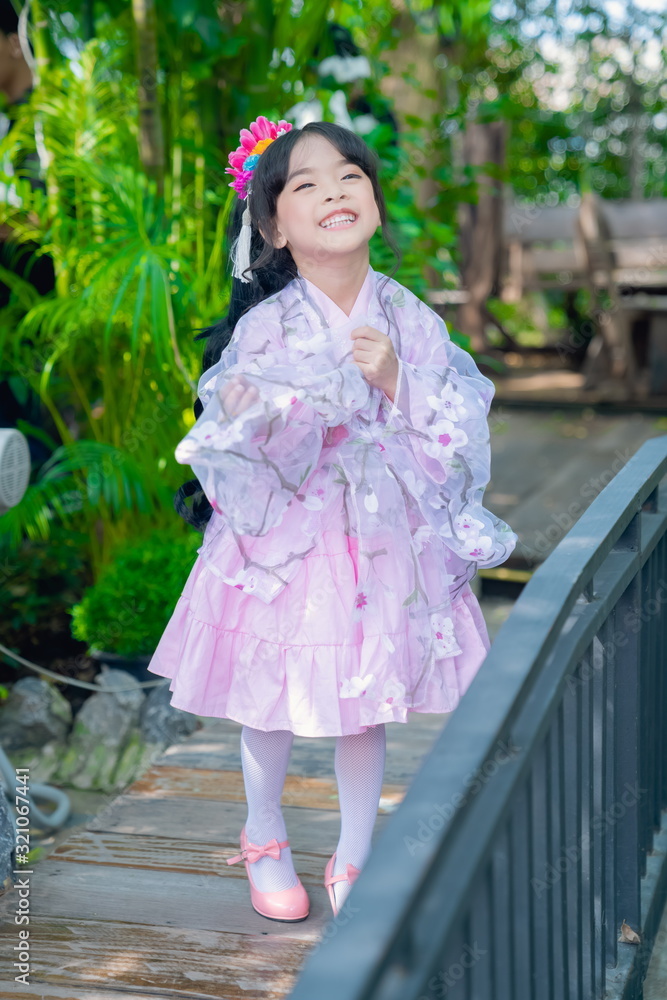 asian little girl Wearing yukata in graden asian little girl Wearing yukata in graden
