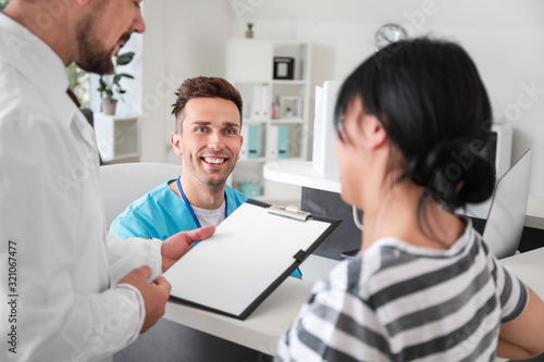 Male doctor with patient ne...