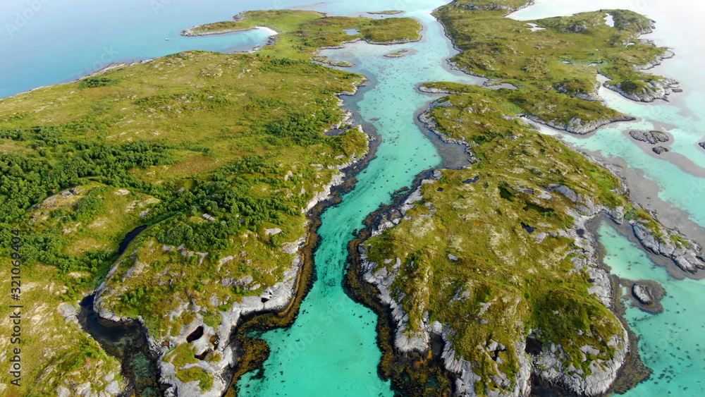 Top view of small islands surrounded by bright turquoise water in between