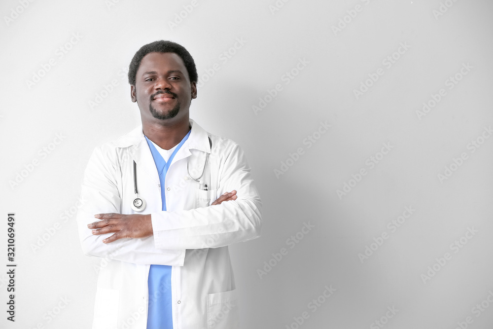 Male African-American doctor on light background Male African-American doctor on light background
